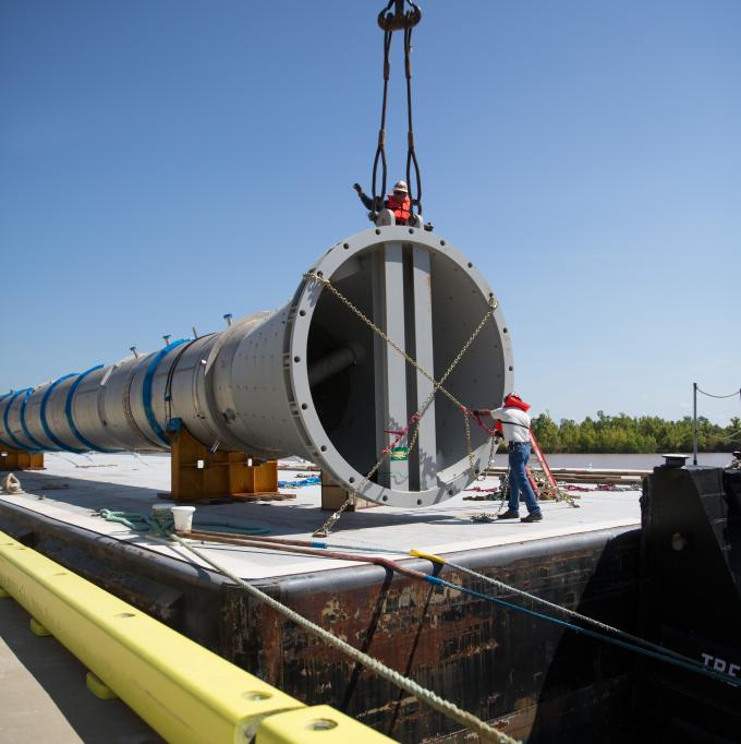 500 and 600 ton cranes ready for a huge double lift from floating barge to 288 tire land transport.